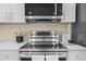 New stainless steel oven, microwave, and stovetop with modern design and white countertops at 7380 Utica St, Westminster, CO 80030