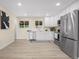 Well-lit kitchen featuring white cabinets and stainless steel appliances at 7380 Utica St, Westminster, CO 80030