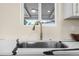 Close-up of a kitchen sink with a modern faucet and a bright window at 7380 Utica St, Westminster, CO 80030