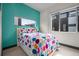 Vibrant bedroom featuring a fun, colorful polka-dot bedspread and ample natural light from the windows at 2539 Lawrence St, Denver, CO 80205