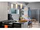 Modern kitchen featuring sleek black appliances, stylish lighting, and an adjacent dining area at 2539 Lawrence St, Denver, CO 80205