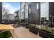 Outdoor patio space with wood decking, black railings, and potted plants for relaxing and entertaining at 2539 Lawrence St, Denver, CO 80205