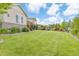 Expansive backyard featuring a lush lawn, landscaping, and a classic home exterior at 5077 W 108Th Cir, Westminster, CO 80031