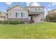Manicured backyard features lush lawn, stone accents, and a covered patio at 5077 W 108Th Cir, Westminster, CO 80031