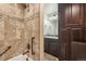 Elegant bathroom with tiled shower, dark wood cabinets, and granite countertops at 5077 W 108Th Cir, Westminster, CO 80031