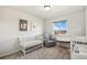Bright Bedroom with crib, glider, and natural light creating a warm and inviting space at 5077 W 108Th Cir, Westminster, CO 80031