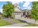 Beautifully landscaped home featuring lush greenery, stone accents, and a spacious driveway at 5077 W 108Th Cir, Westminster, CO 80031