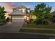 Charming two-story home with a well-manicured lawn and a two-car garage at sunset at 5077 W 108Th Cir, Westminster, CO 80031