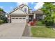 Charming two-story home featuring a two-car garage and a beautifully landscaped front yard with lovely plants at 5077 W 108Th Cir, Westminster, CO 80031