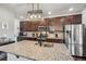 Gourmet kitchen featuring granite countertops, stainless steel appliances, and custom cabinetry at 5077 W 108Th Cir, Westminster, CO 80031