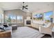 Open living room with vaulted ceilings, a stone fireplace, and large windows showcasing scenic views at 5077 W 108Th Cir, Westminster, CO 80031