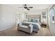 This main bedroom has plush carpets, a ceiling fan, a sitting bench, and a view from the many windows at 5077 W 108Th Cir, Westminster, CO 80031