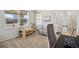 Bright home office with a desk, chair, shelving, natural light, and view of the neighborhood at 5077 W 108Th Cir, Westminster, CO 80031