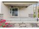 Charming covered patio featuring stone accents, a sliding glass door, and serene outdoor views at 5077 W 108Th Cir, Westminster, CO 80031