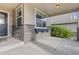 Inviting front porch with stone detailing and a window box, perfect for enjoying the outdoors at 5077 W 108Th Cir, Westminster, CO 80031
