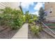 Side yard path with lush greenery and a quaint wooden fence and gate at 5077 W 108Th Cir, Westminster, CO 80031