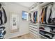 Organized walk-in closet with built-in shelving and drawers, offering ample storage space at 5077 W 108Th Cir, Westminster, CO 80031