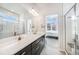 Modern bathroom with double vanity sinks and glass enclosed shower at 522 Meridian Ln, Superior, CO 80027