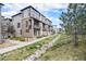 Townhome exterior with lush landscaping, stone accents, and private balconies at 522 Meridian Ln, Superior, CO 80027