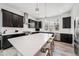 Modern kitchen with a large quartz island, stainless steel appliances, and dark cabinets at 522 Meridian Ln, Superior, CO 80027
