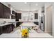 Modern kitchen with stainless steel appliances, center island, and dark cabinetry at 522 Meridian Ln, Superior, CO 80027