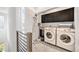 Modern laundry room with washer, dryer, and ample storage cabinets at 522 Meridian Ln, Superior, CO 80027