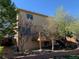 Exterior view of the backyard with a small deck, brick landscaping, and a few trees at 3824 S Quemoy Way, Aurora, CO 80018