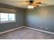 Neutral bedroom featuring plush carpet and a ceiling fan at 3824 S Quemoy Way, Aurora, CO 80018