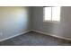 Neutral bedroom features gray walls, plush carpeting, and a bright window at 3824 S Quemoy Way, Aurora, CO 80018