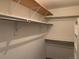 Walk-in closet featuring hanging rods and shelving for storage at 3824 S Quemoy Way, Aurora, CO 80018