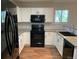 Well-lit kitchen with stainless steel appliances and white cabinetry at 3824 S Quemoy Way, Aurora, CO 80018