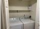 Bright laundry room with washer, dryer and overhead shelf at 3824 S Quemoy Way, Aurora, CO 80018