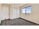 Bright bedroom featuring gray carpet, a window with a view, and ample closet space at 4795 E 98Th Pl, Thornton, CO 80229