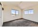 Bright bedroom featuring neutral walls, cozy carpeting, and ample natural light from the large windows, creating a relaxing atmosphere at 4795 E 98Th Pl, Thornton, CO 80229