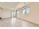 Bright living room featuring sleek flooring, large windows, and a sliding glass door for seamless indoor-outdoor living at 4795 E 98Th Pl, Thornton, CO 80229