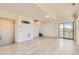 Spacious living room with sleek flooring, sliding glass door, and neutral-toned walls, creating a welcoming and modern space at 4795 E 98Th Pl, Thornton, CO 80229