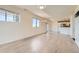 Open-concept living room featuring large windows, light flooring, and seamless flow into the kitchen area, perfect for modern living at 4795 E 98Th Pl, Thornton, CO 80229