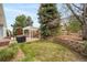 Green backyard with well-maintained lawn, a pergola, and mature trees for privacy and shade at 12136 Desert Hills St, Parker, CO 80138