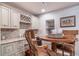 Wet bar featuring countertops, cabinets, wine rack, and bar seating at 12136 Desert Hills St, Parker, CO 80138