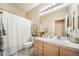 Well-lit bathroom featuring a shower and vanity with a white tiled countertop at 12136 Desert Hills St, Parker, CO 80138