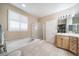 Bathroom featuring a soaking tub, glass enclosed shower, and double vanity at 12136 Desert Hills St, Parker, CO 80138