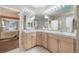 Primary bathroom with double vanity and a glimpse into the main bedroom at 12136 Desert Hills St, Parker, CO 80138