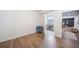 Bright bedroom with wood floors, and neutral walls leading to a bathroom at 12136 Desert Hills St, Parker, CO 80138