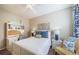 A bedroom with a ceiling fan, neutral wall color and a desk perfect for working at home at 12136 Desert Hills St, Parker, CO 80138