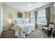 Bright bedroom featuring a ceiling fan, large window, and a patterned bedspread at 12136 Desert Hills St, Parker, CO 80138