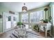 Charming breakfast nook featuring a glass table, ornate chairs, ample windows, and lots of natural light at 12136 Desert Hills St, Parker, CO 80138
