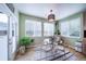Cozy breakfast nook with a glass table, metal chairs, natural lighting, and outdoor views at 12136 Desert Hills St, Parker, CO 80138