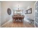 A dining room with hardwood floors, chandelier, and decorative wall art creates an inviting atmosphere at 12136 Desert Hills St, Parker, CO 80138