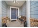 Cozy front porch with a bench and decorative lanterns, offering a warm welcome to guests at 12136 Desert Hills St, Parker, CO 80138