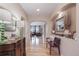 Bright hallway with hardwood floors, elegant decor, and arched openings leading to other living spaces at 12136 Desert Hills St, Parker, CO 80138